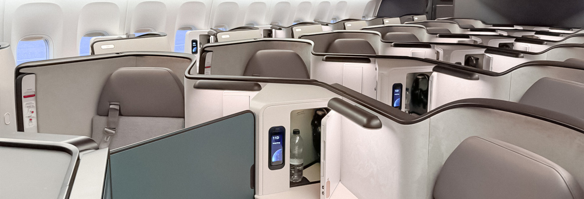 Interior de cabina de avión con asientos business class